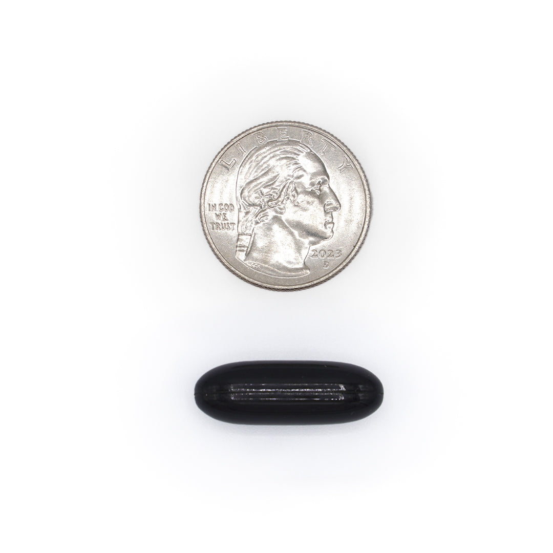 Potassium Citrate black softgel size comparison with a quarter coin