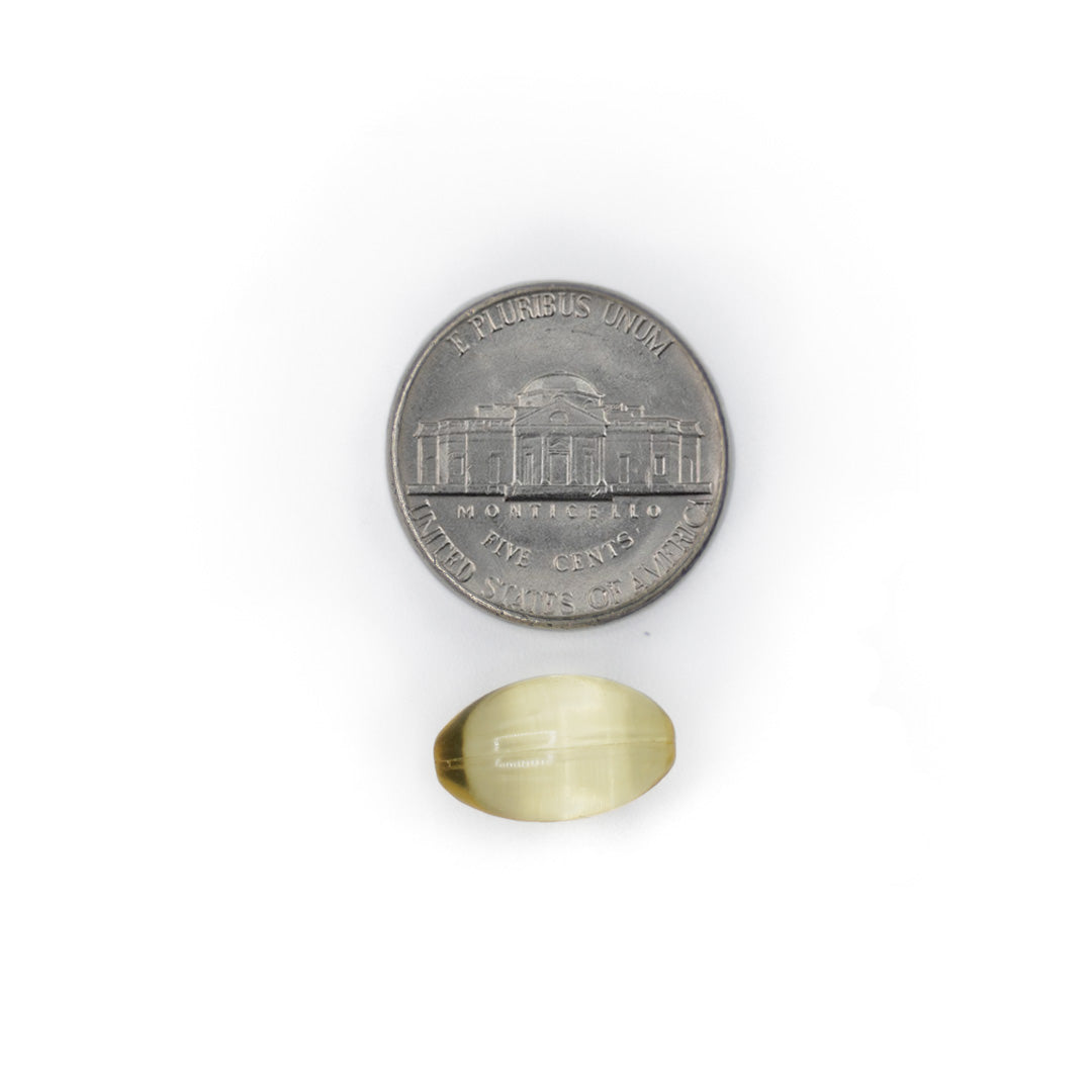 Vitamin E 400 IU softgel shown next to a coin for size comparison.
