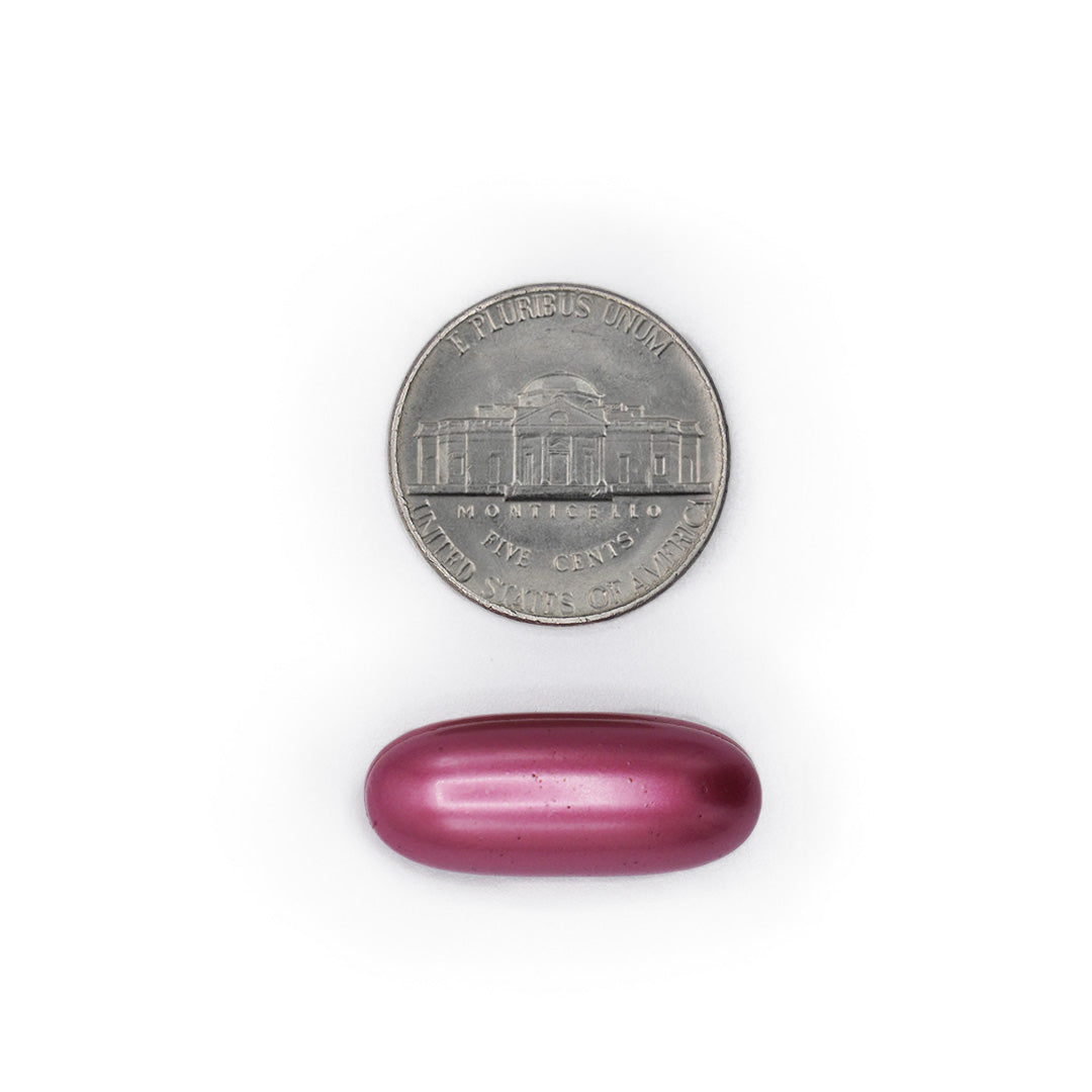 3 Beauty Complex pink softgel size comparison with a five cent coin