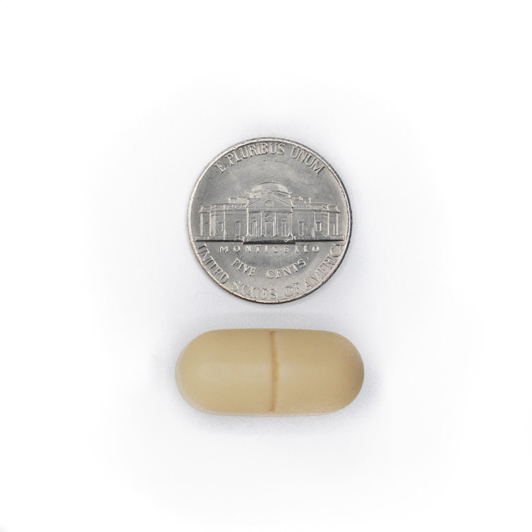 SIMOVE caplet size comparison shown next to a U.S. nickel coin.