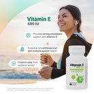 Active woman holding water with Vitamin E 400 IU supplement for antioxidant, cardiovascular, and immune support