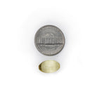 Vitamin E 400 IU softgel shown next to a coin for size comparison.